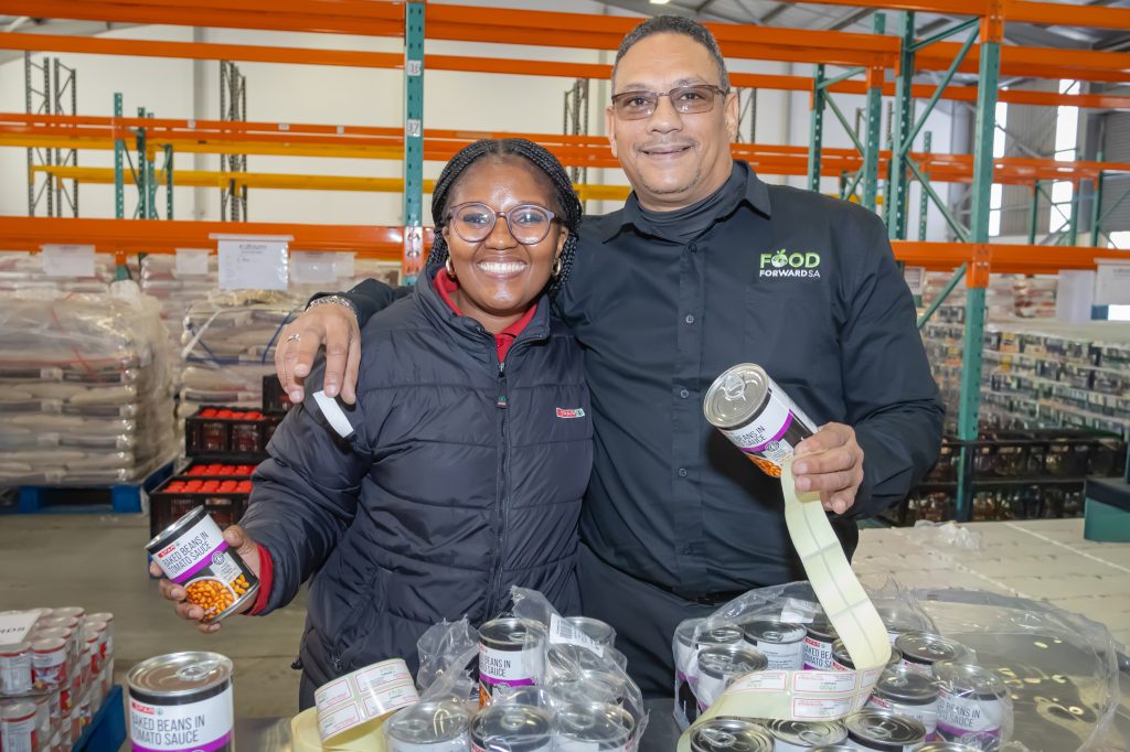 Volunteers from SPAR Eastern Cape and FoodForward SA packing food parcels during a Mandela Day initiative in Gqeberha to support vulnerable communities.