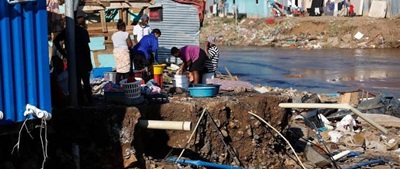Residents living in a South African informal settlement facing infrastructure challenges